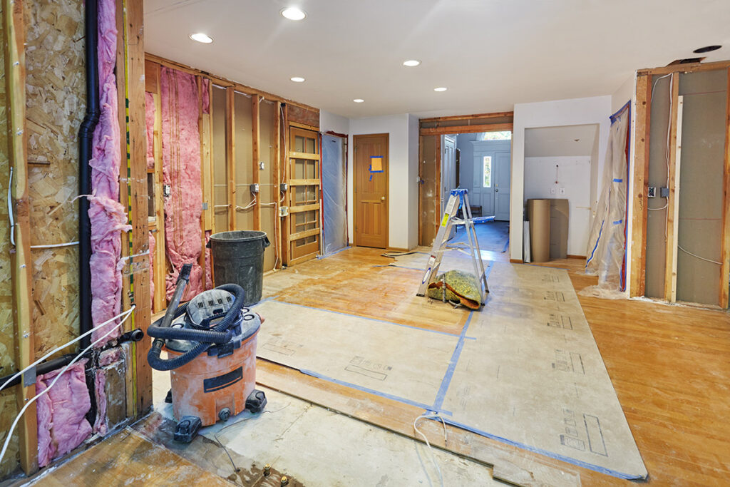 A home renovation taking place, connected to a preexisting, finished hallway.