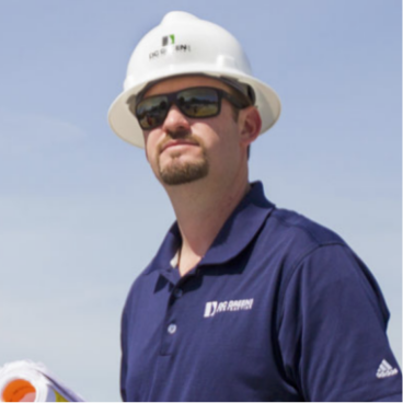 A construction worker with their hard hat on.
